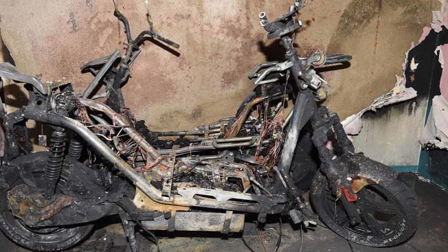 Burnt out e-bike/scooter in a fire damaged interior